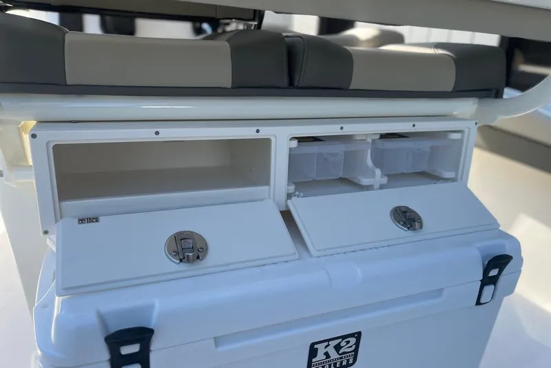 Slide: The Image of Key West 219 FS 2026 boat storage compartments with K2 cooler, open and ready for use. - 9