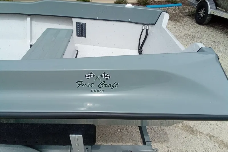 Slide: The Image of Fast Craft XR15 boat, 2025 model, gray exterior with logo and checkered flags. - 8