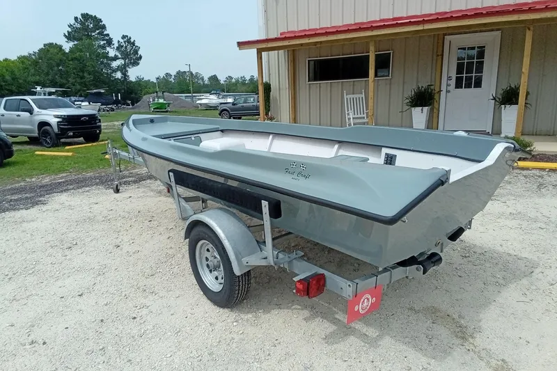 Slide: The Image of 2025 Fast Craft XR15 boat on trailer, parked outside a building. - 9