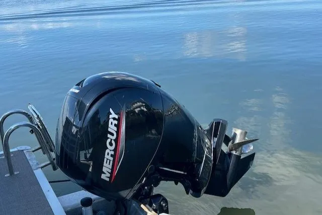 Slide: The Image of Outboard motor on 2023 Sun Tracker Party Barge 22 DLX, Mercury engine, calm water background. - 10