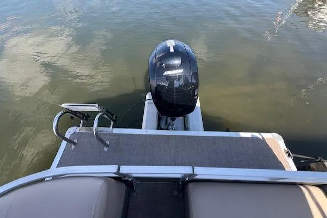 Slide: The Image of 2023 Sun Tracker Party Barge 22 DLX pontoon boat with outboard motor on calm water. - 11