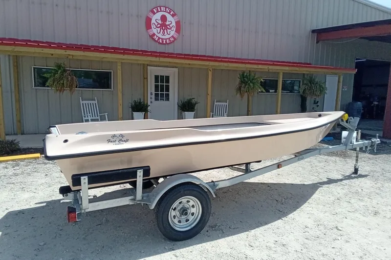 Slide: The Image of 2025 Fast Craft XR15 boat on trailer outside First Mates building. - 3