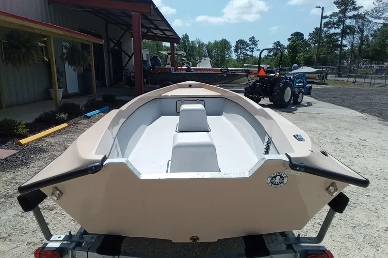 Slide: The Image of Fast Craft XR15 boat, 2025 model, on trailer outside a workshop under a clear sky. - 4