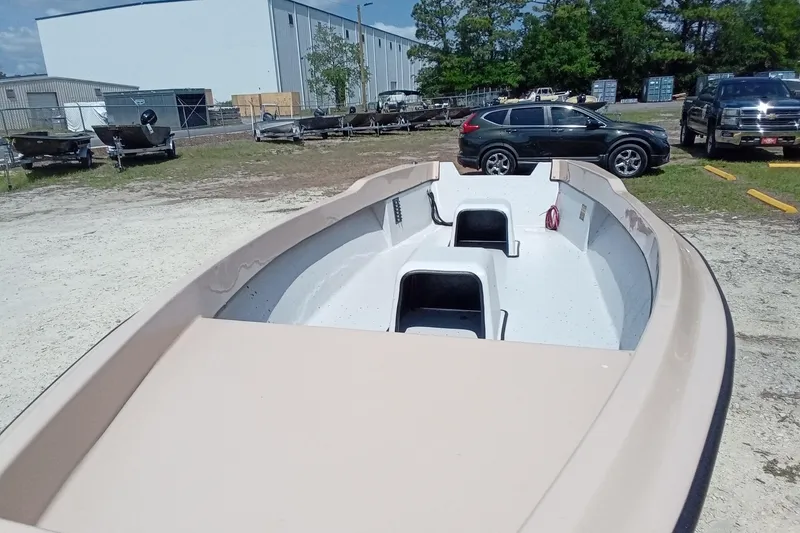 Slide: The Image of 2025 Fast Craft XR15 boat in a parking lot with cars and trees. - 7