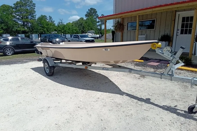 Slide: The Image of 2025 Fast Craft XR15 boat on trailer, parked outdoors near a building. - 9