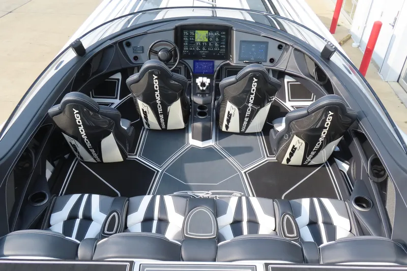 Slide: The Image of 2024 MTI 440X boat interior with sleek black and white seating and advanced dashboard technology. - 10