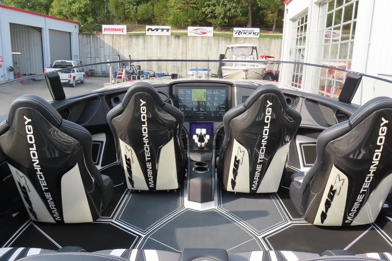 Slide: The Image of Interior of 2024 MTI 440X boat with advanced dashboard and Marine Technology seats. - 16