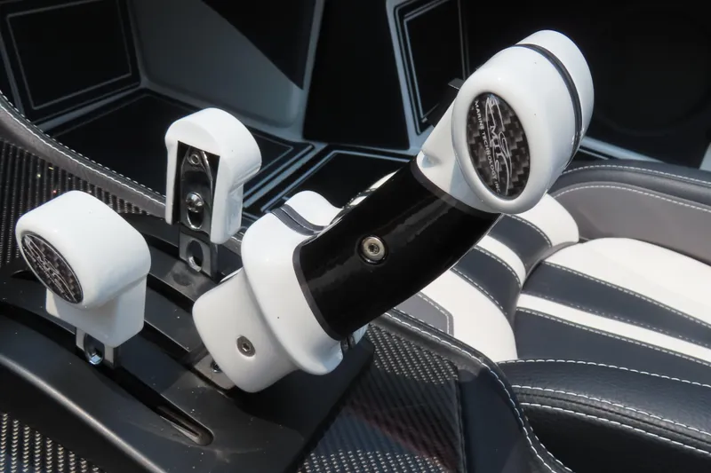 Slide: The Image of Throttle controls of 2024 MTI 440X boat, featuring sleek black and white design. - 19