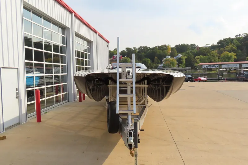 Slide: The Image of 2024 MTI 440X boat on trailer outside a modern garage. - 3