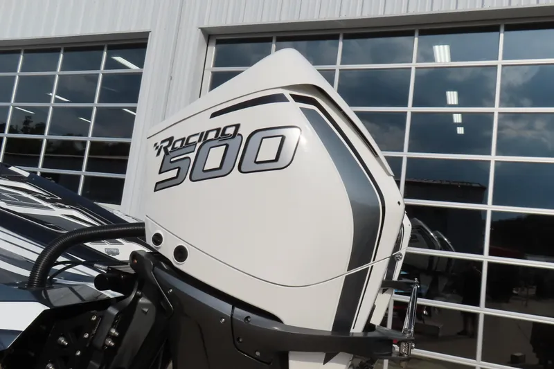 Slide: The Image of 2024 MTI 440X Racing 500 engine detail outside a modern garage. - 6