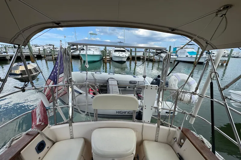 Slide: The Image of Cockpit view of a 1995 Island Packet 32 sailboat docked at a marina. - 16