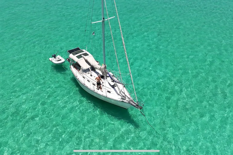 Slide: The Image of Sailboat Island Packet 32 (1995) anchored in clear turquoise waters, aerial view. - 2