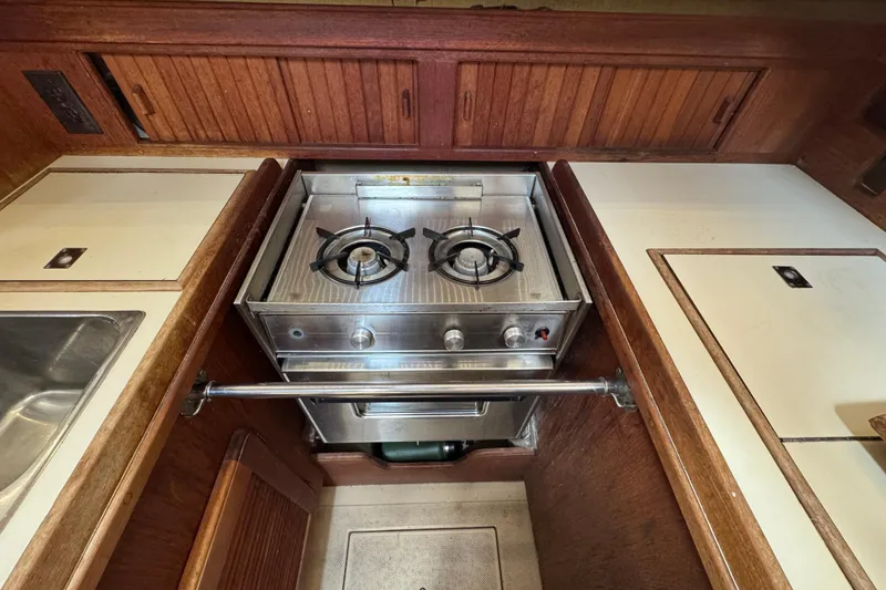 Slide: The Image of Compact galley kitchen in 1995 Island Packet 32 sailboat with dual-burner stove. - 24