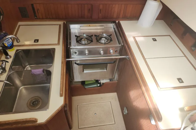 Slide: The Image of Galley kitchen in 1995 Island Packet 32 sailboat with stove and sink. - 25
