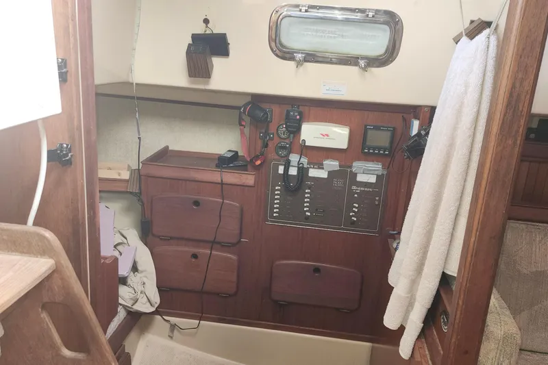 Slide: The Image of Interior of a 1995 Island Packet 32 sailboat with navigation equipment and storage. - 26