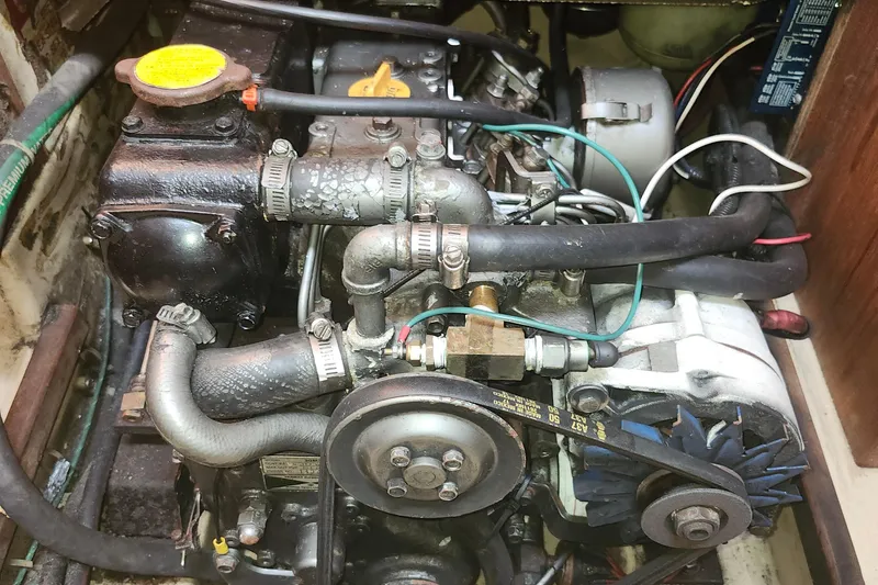 Slide: The Image of Engine compartment of a 1995 Island Packet 32 sailboat, showing detailed mechanical components. - 39