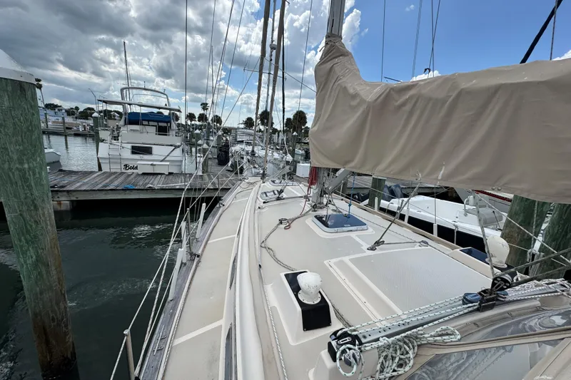Slide: The Image of 1995 Island Packet 32 sailboat docked at marina under cloudy sky. - 8