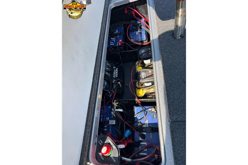 Slide: The Image of 2019 Ranger Z520L boat battery compartment with wiring and NOCO Genius charger. - 12