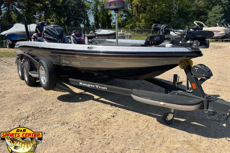 Slide: The Image of 2019 Ranger Z520L boat on trailer at D&R Sports Center, parked on sandy ground. - 2