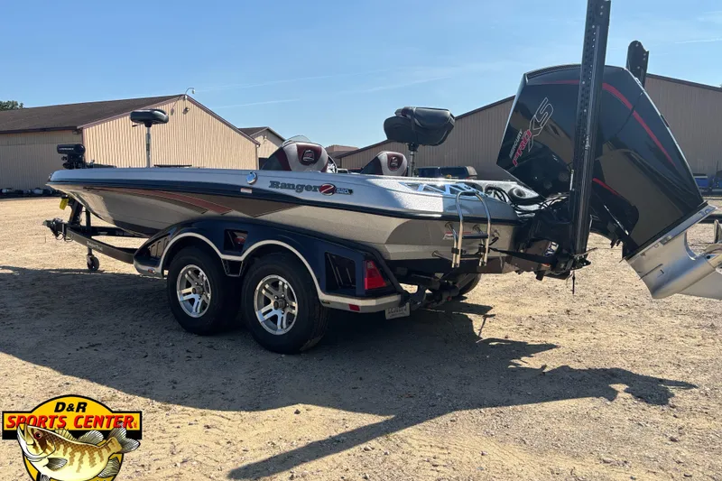 Slide: The Image of 2019 Ranger Z520L boat on trailer, parked outdoors, featuring dual axles and powerful outboard motor. - 3