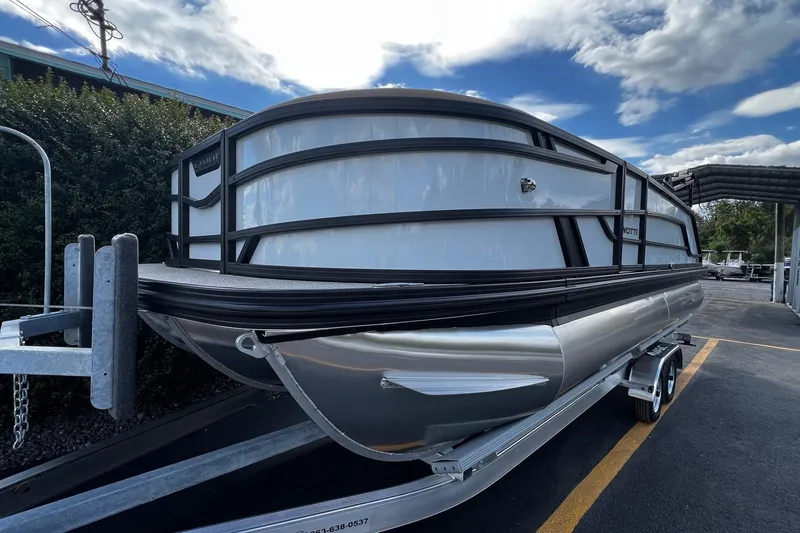 Slide: The Image of 2026 Evotti 521CS pontoon boat on trailer under cloudy sky. - 2