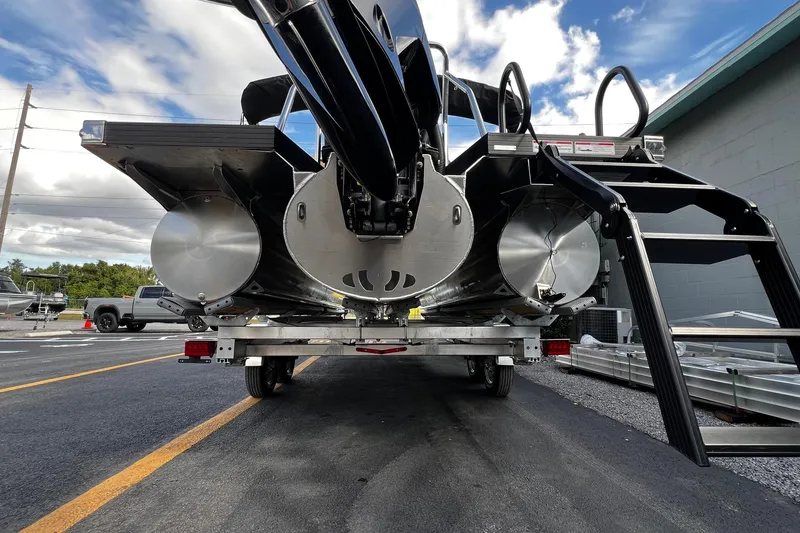 Slide: The Image of Rear view of 2026 Evotti 521CS boat on trailer, showcasing pontoons and ladder. - 3