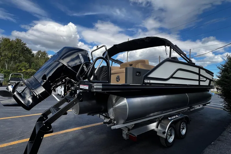 Slide: The Image of 2026 Evotti 521CS pontoon boat with Mercury engine on trailer, under blue sky. - 4