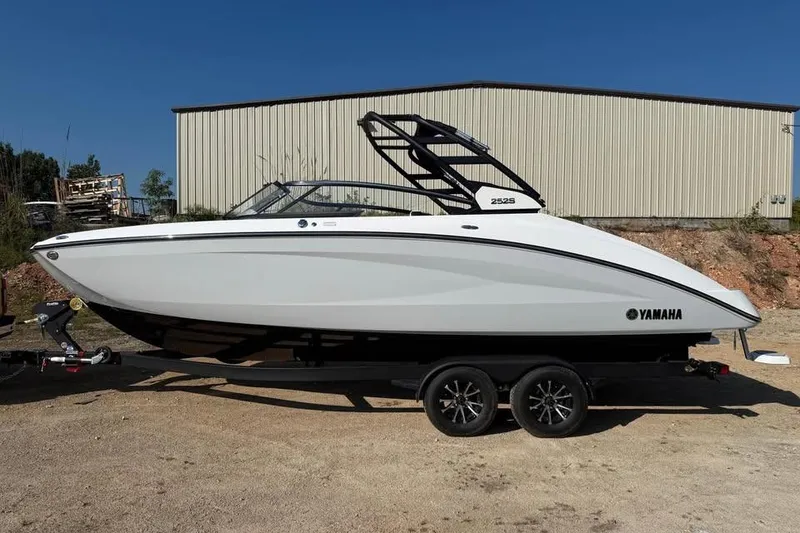 The Image of 2026 Yamaha Boats 252S on trailer, sleek design, parked outdoors. - 0