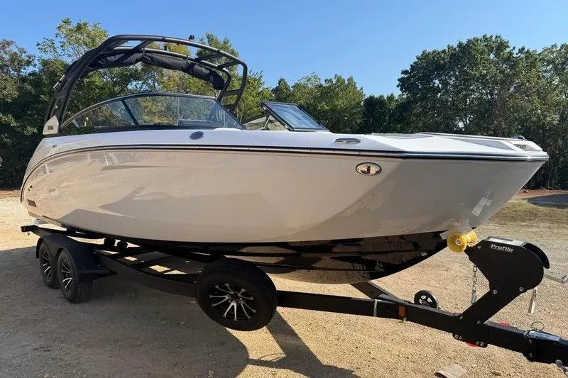 Slide: The Image of 2026 Yamaha Boats 252S on trailer, sleek design, parked outdoors. - 2