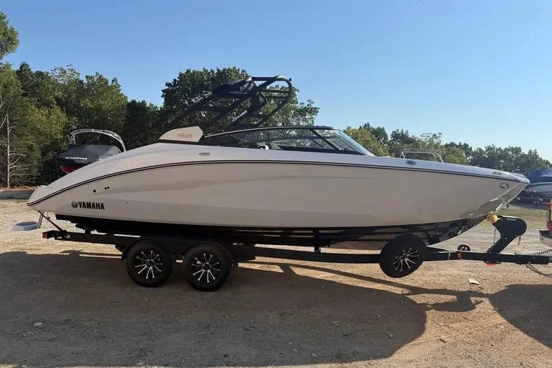 Slide: The Image of 2026 Yamaha Boats 252S on trailer, parked outdoors, side view. - 3