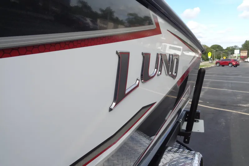 Slide: The Image of 2026 Lund 1875 Crossover XS boat, close-up of logo and design details. - 11