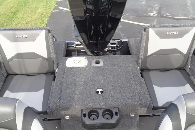 Slide: The Image of 2026 Lund 1875 Crossover XS boat interior with gray seating and storage compartments. - 13