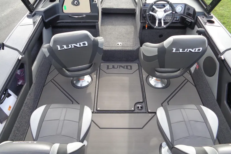 Slide: The Image of 2026 Lund 1875 Crossover XS boat interior with four seats and steering console. - 15