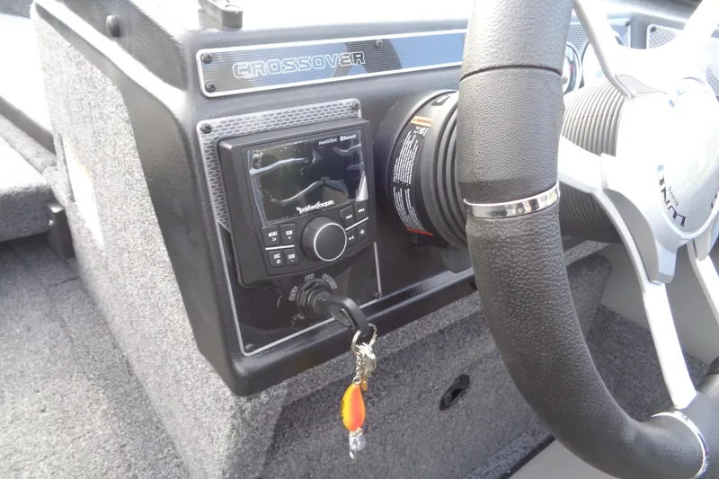 Slide: The Image of 2026 Lund 1875 Crossover XS dashboard with steering wheel and audio system. - 19