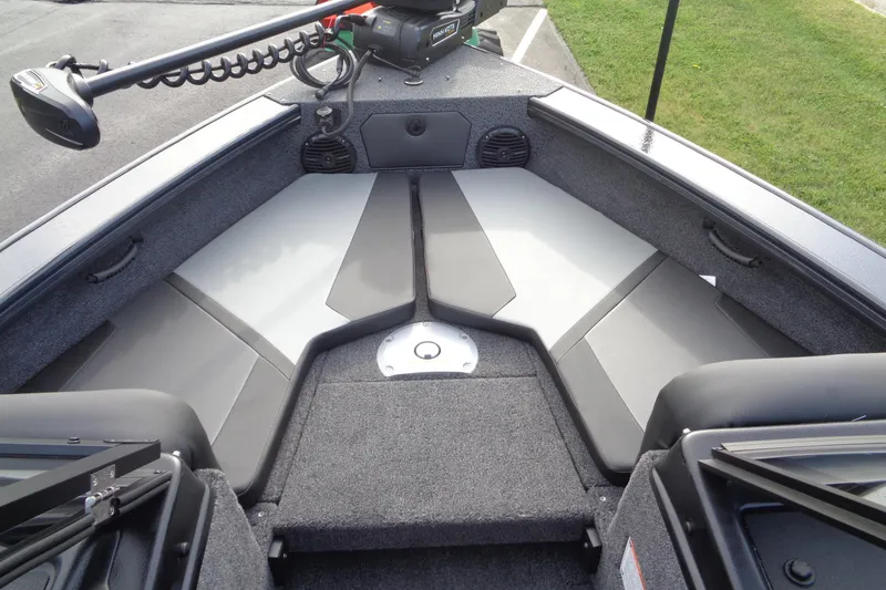 Slide: The Image of 2026 Lund 1875 Crossover XS boat interior with seating and storage compartments. - 21