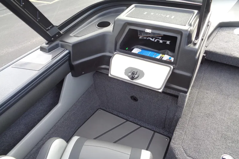 Slide: The Image of 2026 Lund 1875 Crossover XS boat interior with storage compartment and seating. - 22