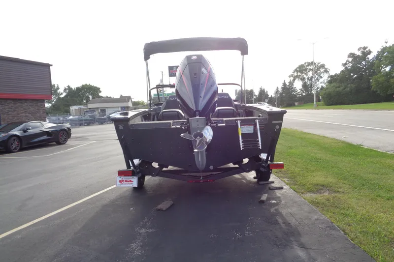 Slide: The Image of 2026 Lund 1875 Crossover XS boat on trailer, rear view, parked outdoors. - 4