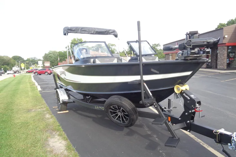 Slide: The Image of 2026 Lund 1875 Crossover XS boat on trailer in parking lot. - 8