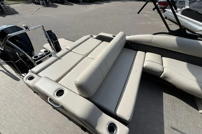 Slide: The Image of 2020 Barletta L23U pontoon boat with beige seating and cup holders. - 12
