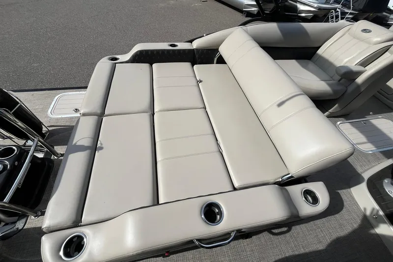 Slide: The Image of 2020 Barletta L23U boat with beige seating and cup holders on deck. - 13