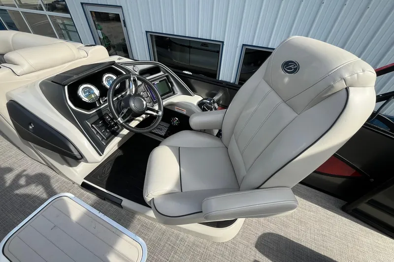 Slide: The Image of 2020 Barletta L23U boat interior with steering console and luxurious captain's chair. - 17
