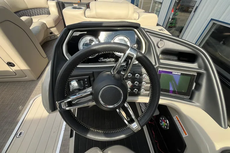 Slide: The Image of 2020 Barletta L23U boat dashboard with steering wheel and navigation system. - 18