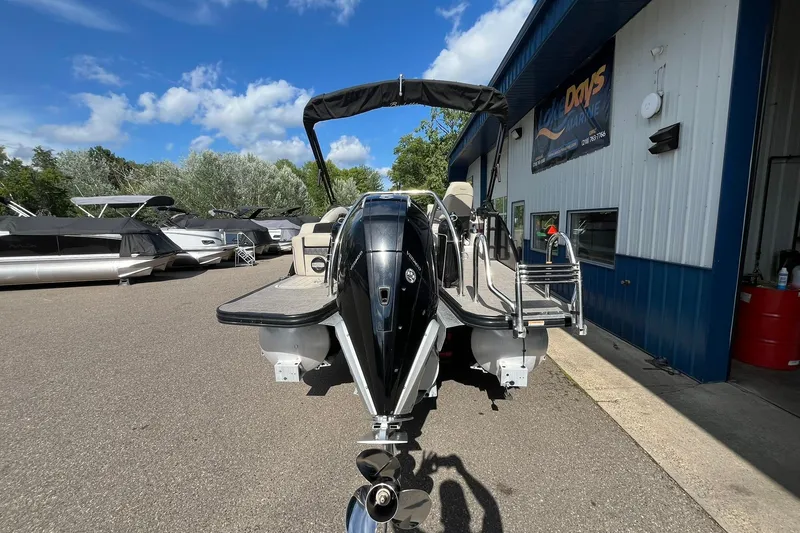 Slide: The Image of 2020 Barletta L23U pontoon boat at a marina, sunny day, blue sky. - 2