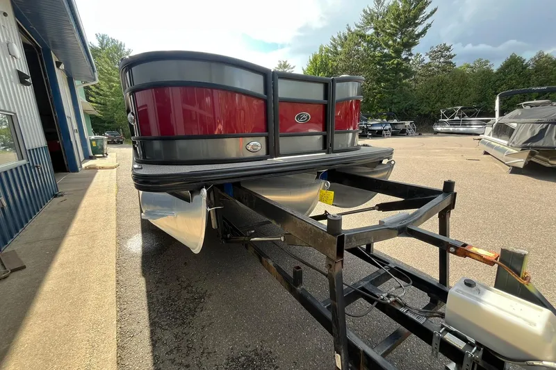 Slide: The Image of 2020 Barletta L23U pontoon boat on trailer, parked outdoors near a building. - 5