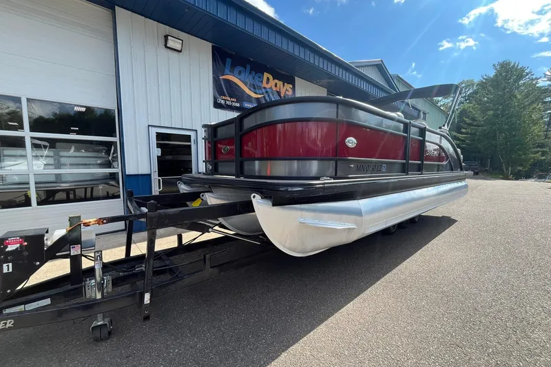 Slide: The Image of 2020 Barletta L23U pontoon boat on trailer outside dealership. - 6