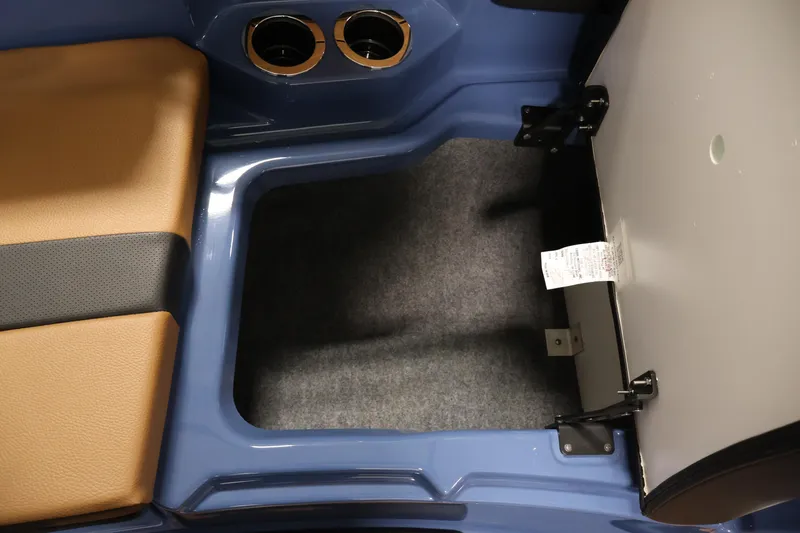 Slide: The Image of 2026 Yamaha Boats 222XD storage compartment with cushioned seating and cup holders. - 15