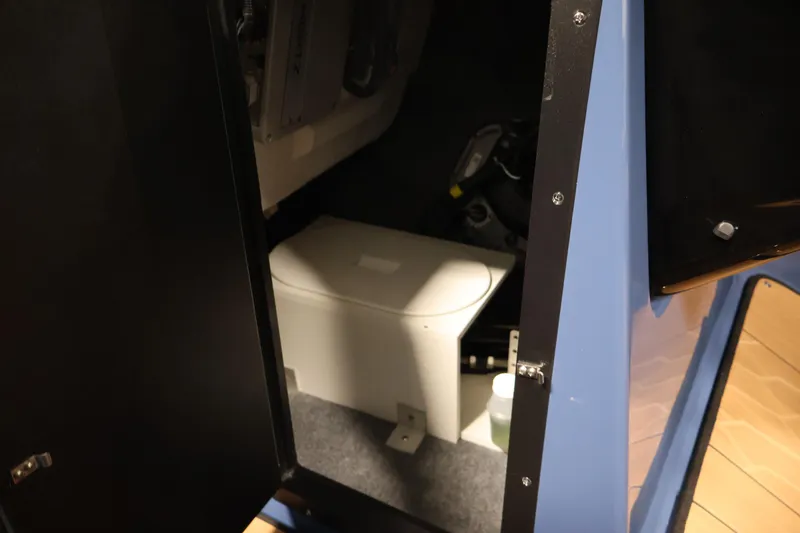 Slide: The Image of Interior view of 2026 Yamaha Boats 222XD storage compartment with equipment. - 19