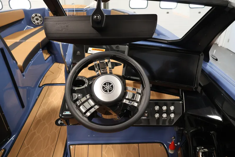Slide: The Image of Interior view of 2026 Yamaha Boats 222XD, featuring sleek steering and modern dashboard. - 21