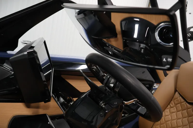 Slide: The Image of Interior view of 2026 Yamaha Boats 222XD, featuring steering wheel and dashboard controls. - 24
