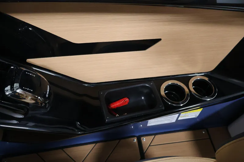 Slide: The Image of Interior of 2026 Yamaha Boats 222XD, featuring control panel and cup holders. - 28